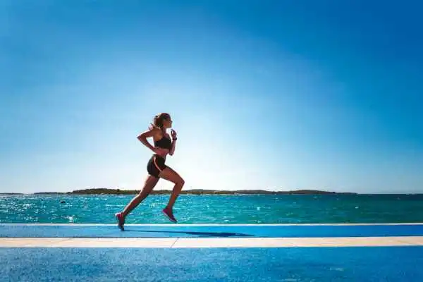 Woman running showing strong leg muscle Allesley